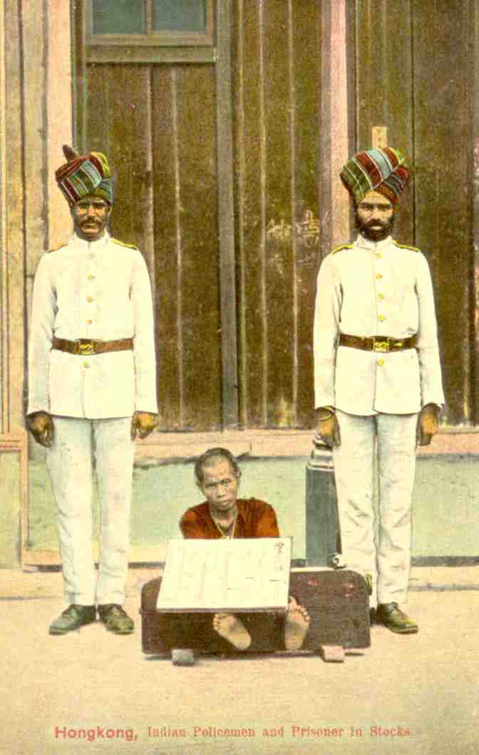 Indian Policemen and Prisoner in Stocks