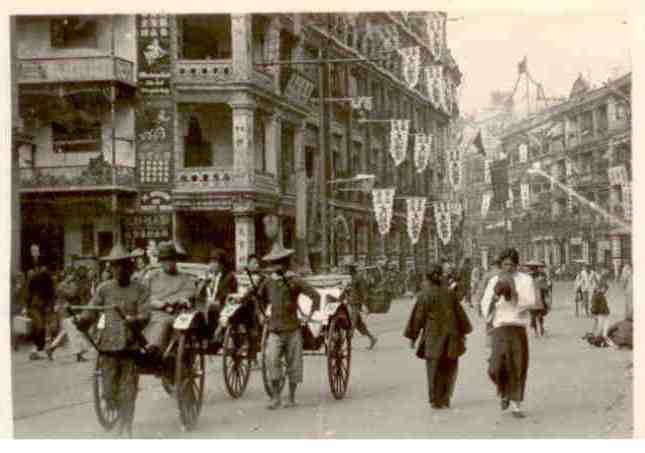 Main street and rickshaws (photograph)