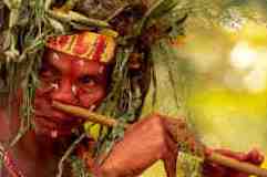 Orang asli playing nose flute