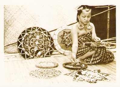 Kayan woman working with beads