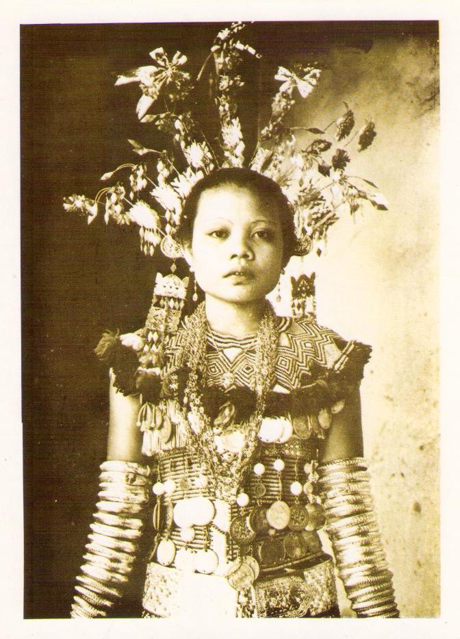 A young Iban girl in ceremonial dress of yesteryear