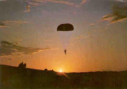 Defence forces parachute at sunset