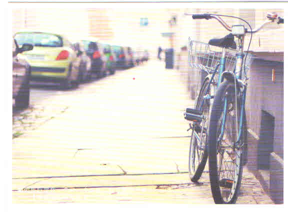 Green bicycle on footpath