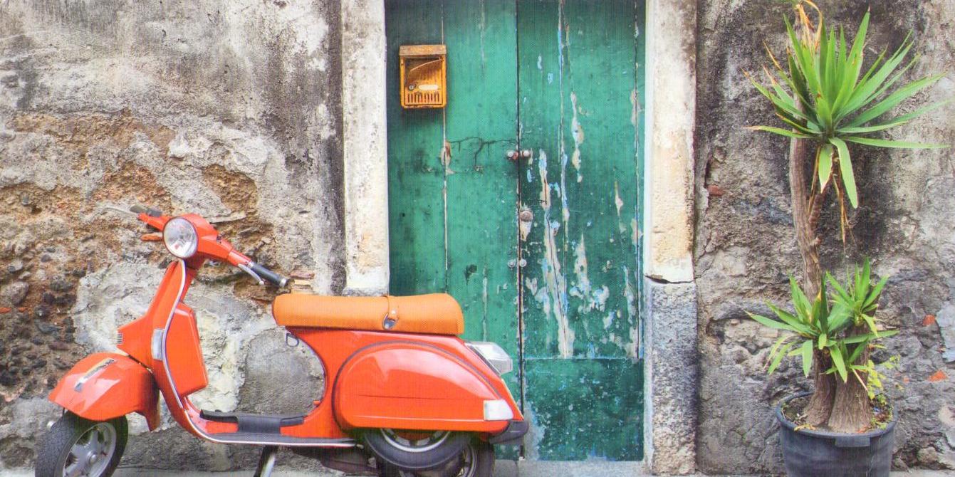 Red scooter at green door